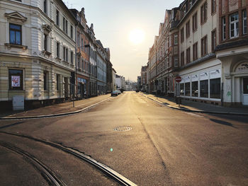 Street amidst buildings against sky in city