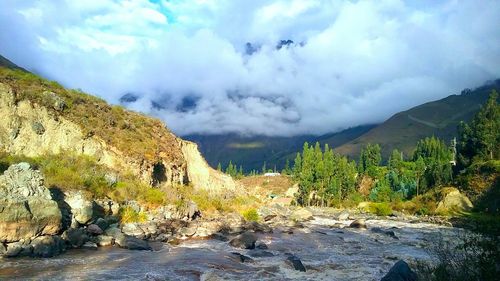 Scenic view of mountains against cloudy sky