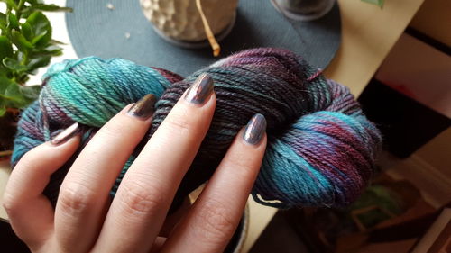 Close-up of woman hand holding wool ball