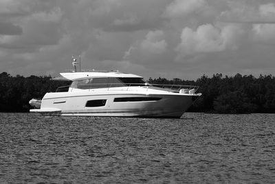 Ship moored on lake against sky