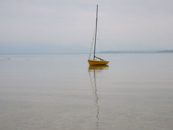 Sailboat on sea against sky