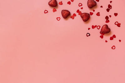 Directly above shot of christmas decoration against pink background