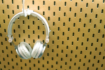 Close-up of headphones hanging on wall