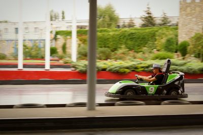 Side view of woman driving go-cart