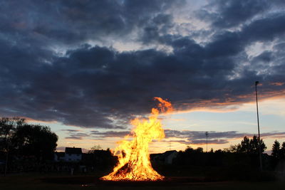 View of bonfire against cloudy sky