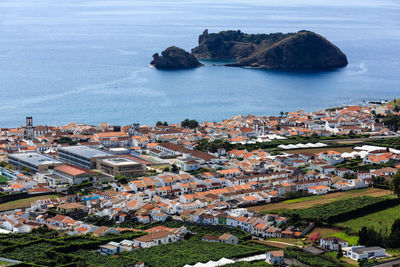 High angle view of townscape by sea