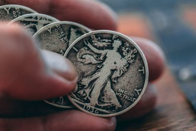 Cropped image of hand holding coins