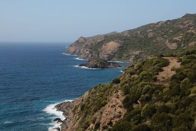 Scenic view of sea with rocks in background