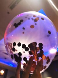 Close-up of hand holding crystal ball