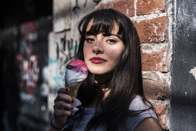 Portrait of young woman holding ice cream cone