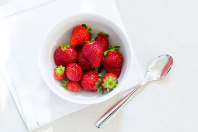 High angle view of strawberries in bowl on table