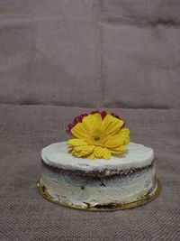 Close-up of yellow rose on table