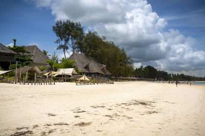 Scenic view of beach and building against sky