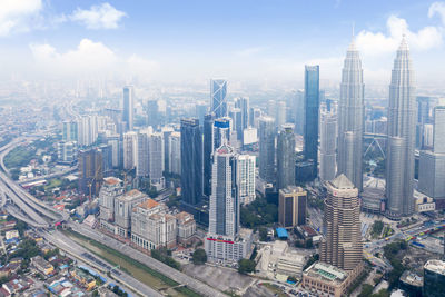 Aerial view of modern buildings in city against sky