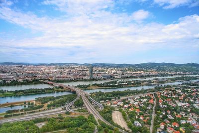 High angle view of river amidst buildings in city against sky