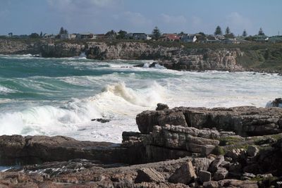 Scenic view of sea and rocks against sky