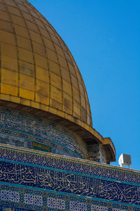 Low angle view of building against blue sky