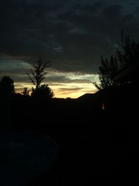 Silhouette trees against sky at sunset