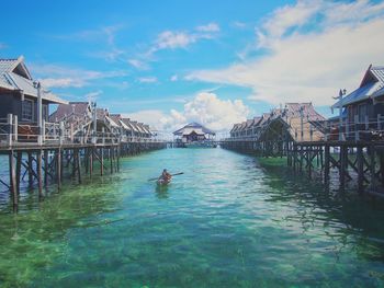 Scenic view of sea and houses against sky