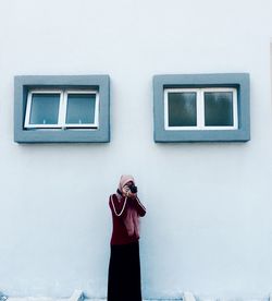 Low angle view of woman using mobile phone