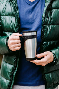 Midsection of man holding drink