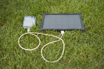 High angle view of smart phone on field