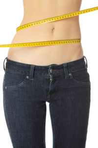 Midsection of woman standing against white background