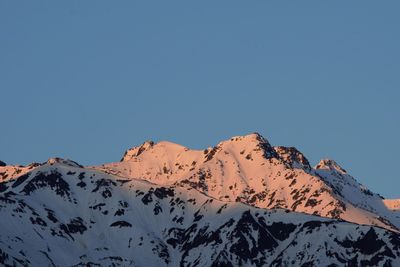 Scenic view of snowcapped mountains against clear blue sky