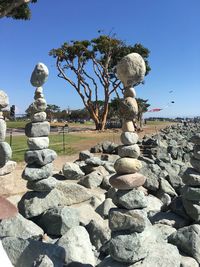 Statues on rocks against clear sky