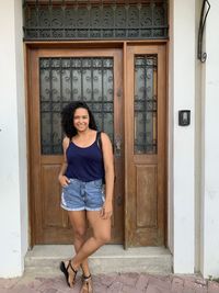 Low section of woman standing against wall