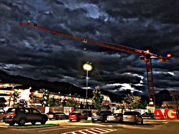 Traffic on road against sky at night