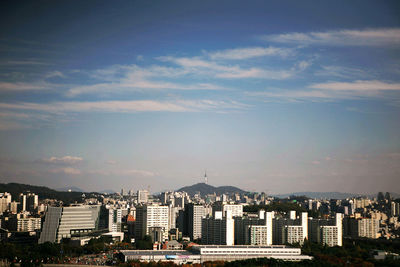 Cityscape against cloudy sky