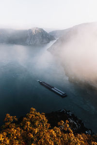 High angle view of lake and mountains against sky