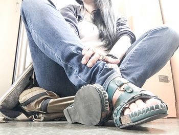 Low section of woman sitting on floor