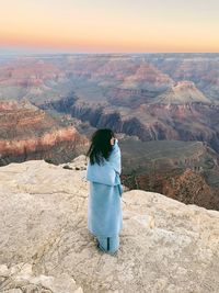 Woman standing at grand canyon national park during sunrise