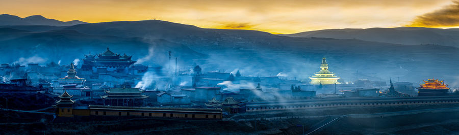 Panoramic view of buildings against sky during sunset