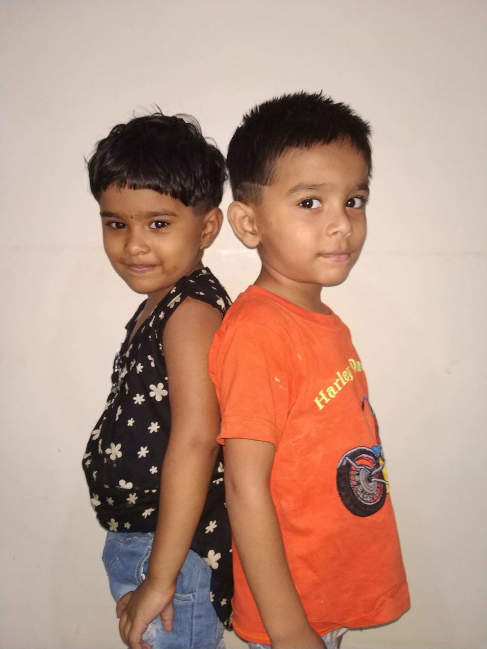 childhood, two people, togetherness, child, indoors, boys, bonding, males, looking at camera, sibling, females, men, women, casual clothing, portrait, family, three quarter length, sister, innocence, positive emotion