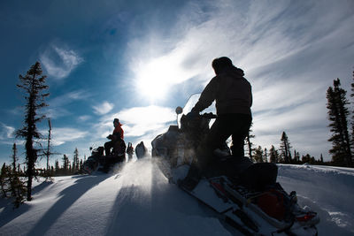 Rear view of man standing on snow