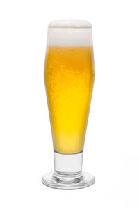 Close-up of beer glass against white background