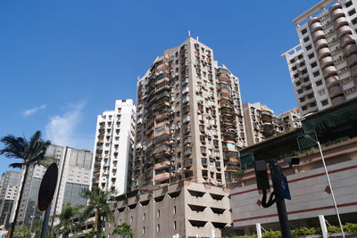Low angle view of buildings against clear blue sky