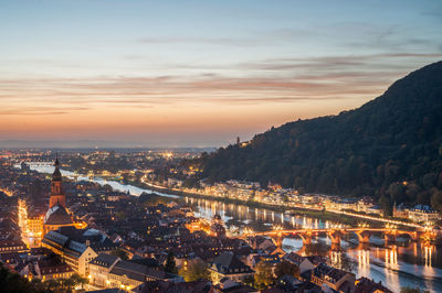 High angle view of illuminated buildings against sky during sunset