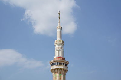 Low angle view of tower and building against sky