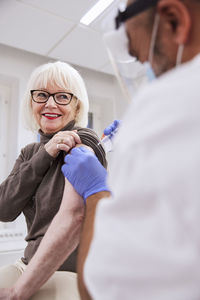 Senior woman getting vaccinated against covid-19