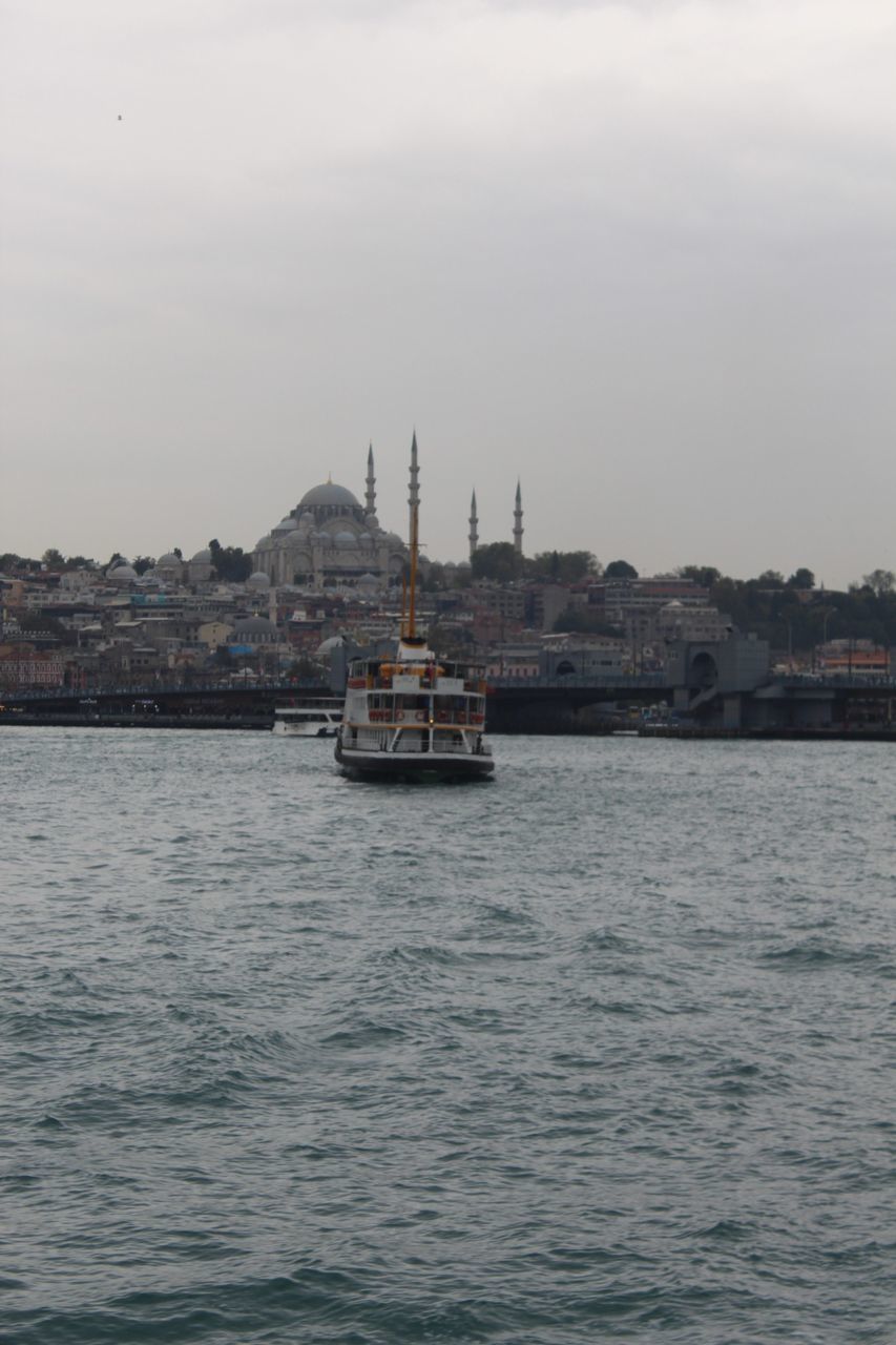 nautical vessel, water, transportation, boat, mode of transport, waterfront, passenger craft, built structure, river, outdoors, architecture, sky, building exterior, nature, ferry, day, no people, sailing, rippled, city, travel destinations, harbor, moored, sailboat, clear sky, beauty in nature, mountain, yacht, mast, cityscape