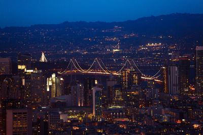 High angle view of city lit up at night