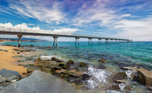 Bridge over sea against sky