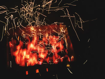 Low angle view of firework display at night