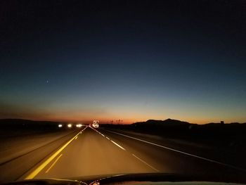 Road against sky at night