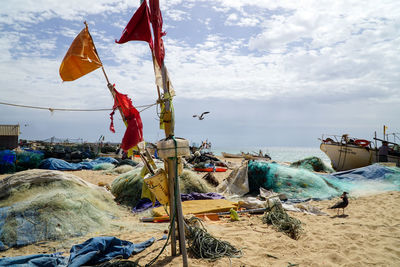 Fishing net on beach against sky