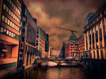 Buildings in city against cloudy sky